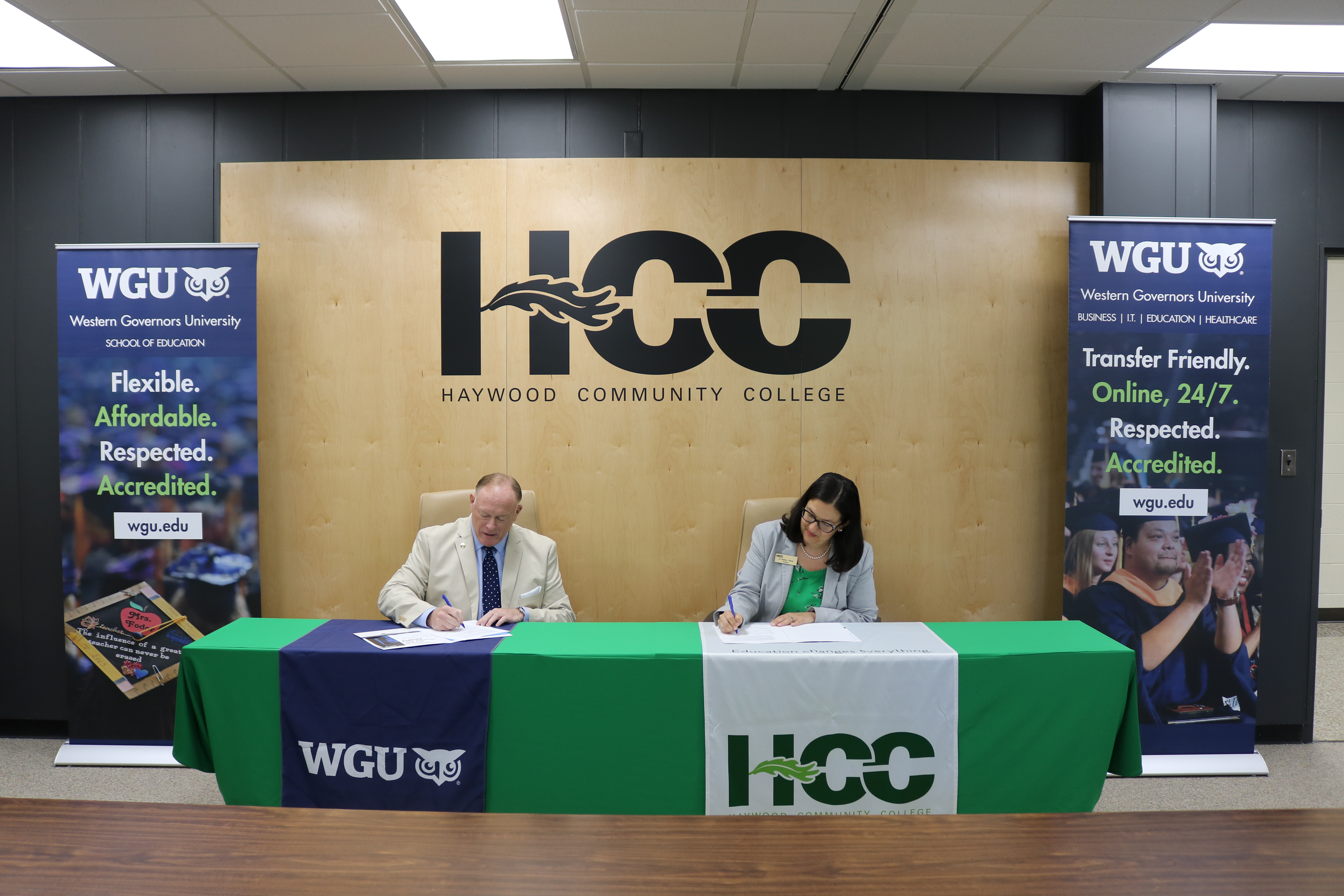 Ben Coulter and Shelley White signing agreement